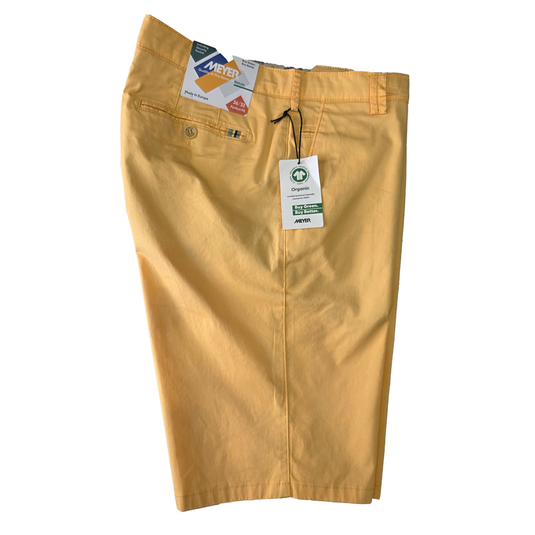 Yellow shorts with tags on a white background