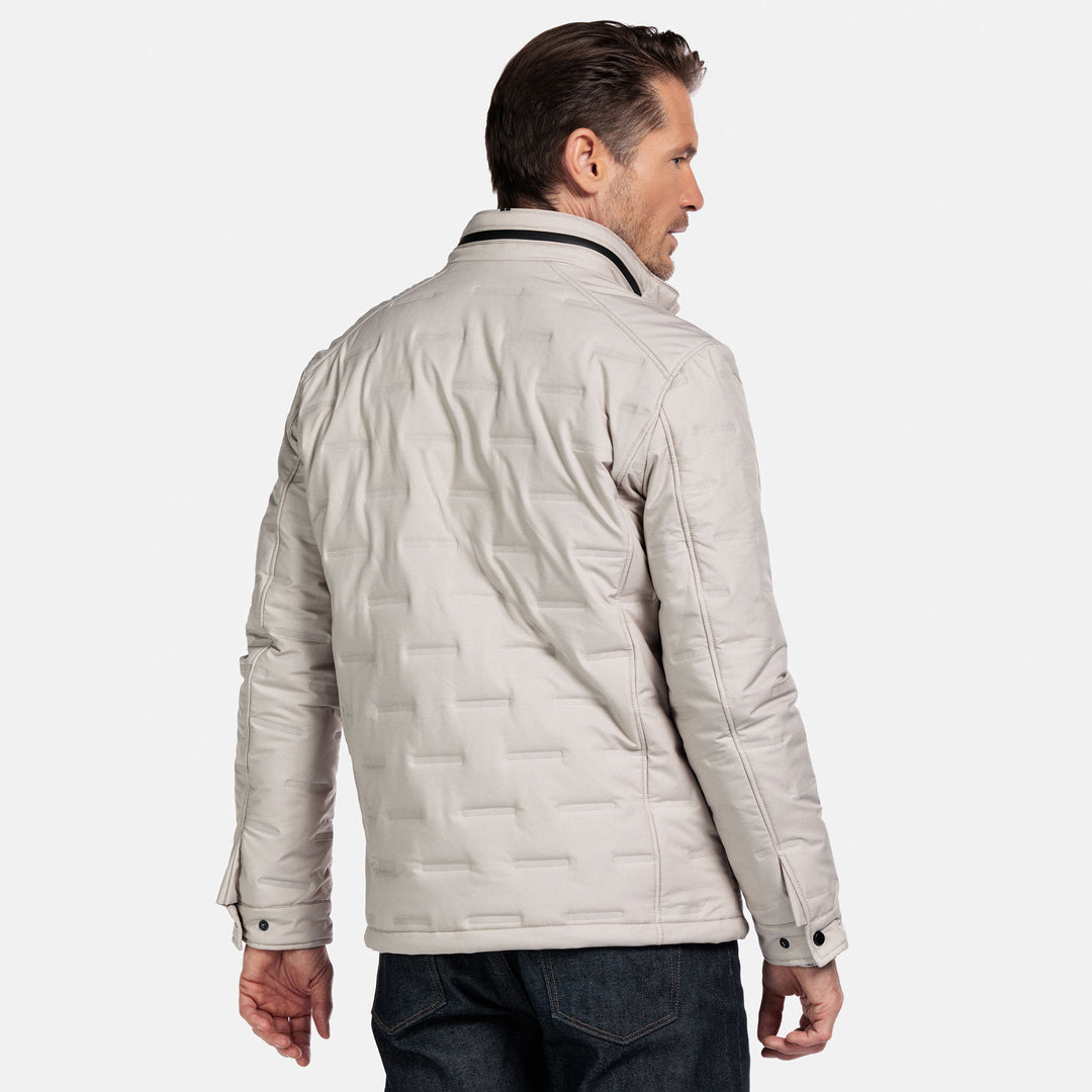 Man wearing a beige jacket on a white background