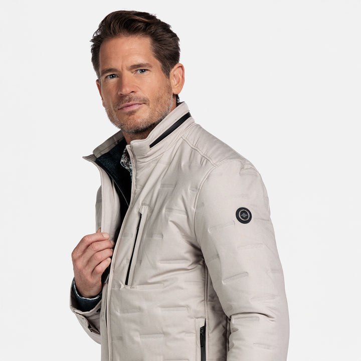 Man wearing a beige jacket on a white background