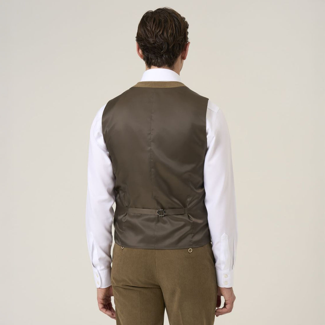 Man wearing a brown vest over a white shirt on a beige background