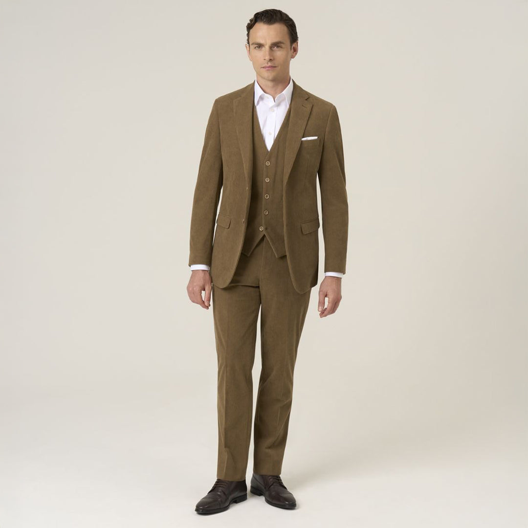 Man wearing a brown suit with a white shirt on a plain background