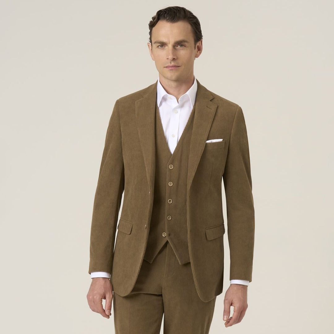 Man wearing a brown suit with a white shirt on a beige background