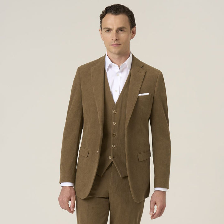 Man wearing a brown suit with a white shirt on a beige background