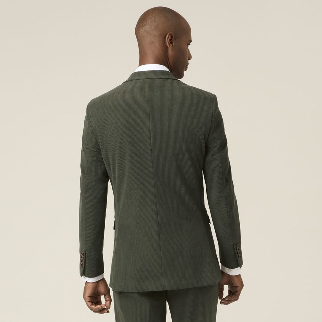 Man wearing a green suit jacket on a beige background