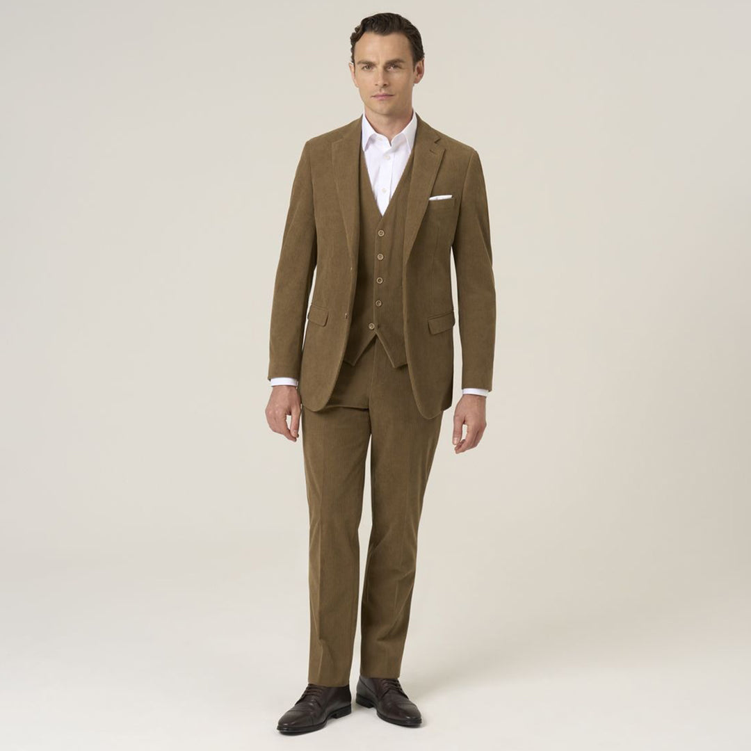 Man wearing a brown suit with a white shirt on a plain background