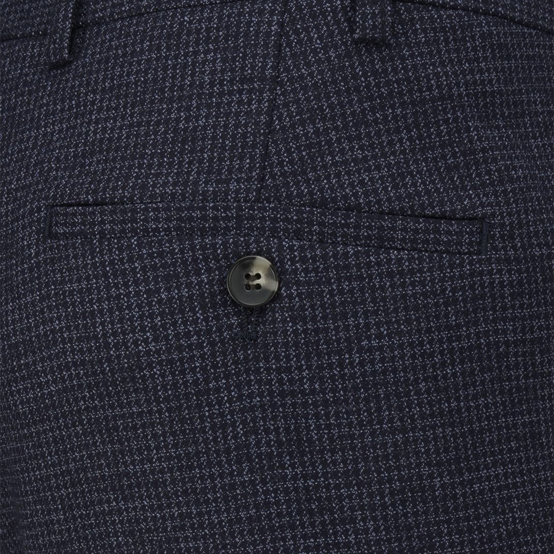 Close-up of a button on a textured navy blue fabric