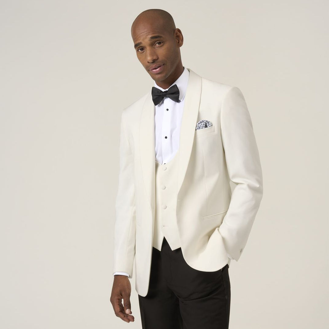 Man wearing a white tuxedo with a black bow tie against a plain background