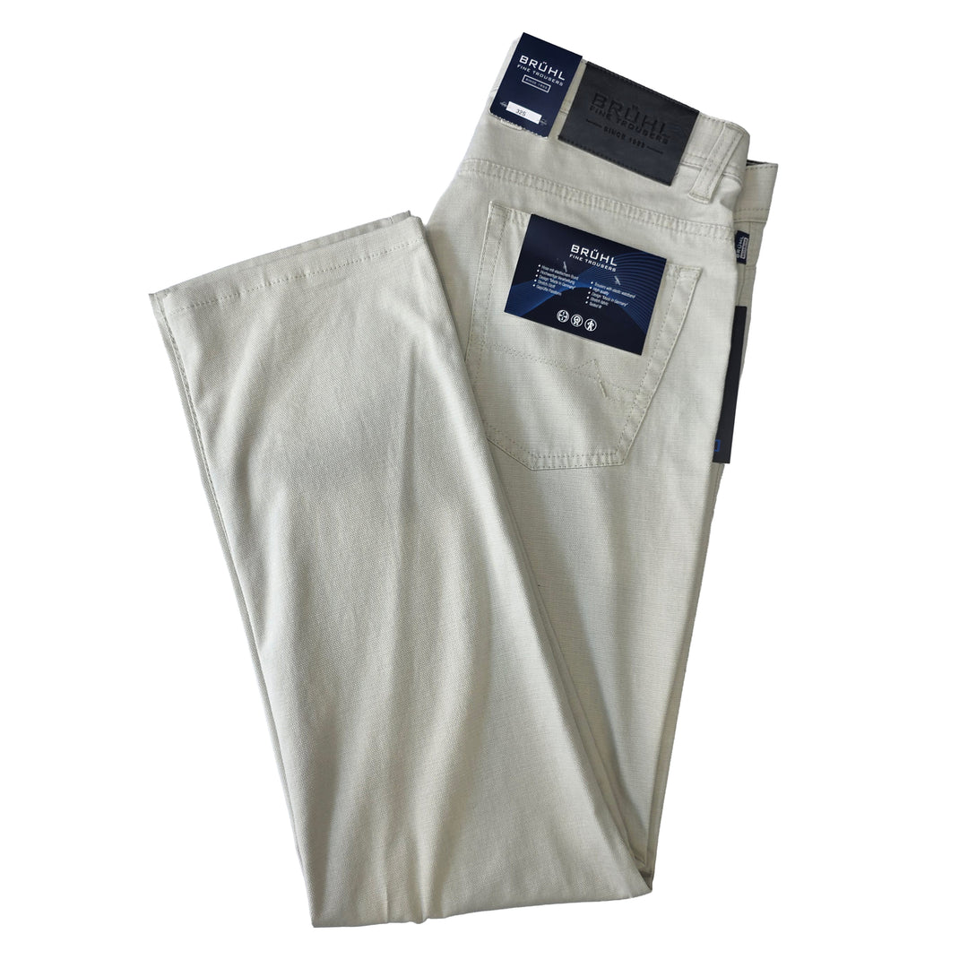 Folded beige pants with Bruhl labels on a white background