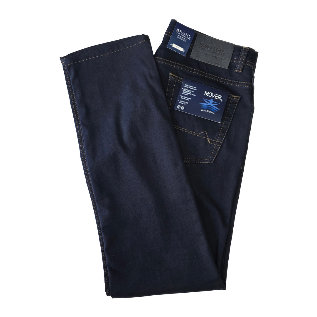 Folded dark blue jeans with a brand label on a white background