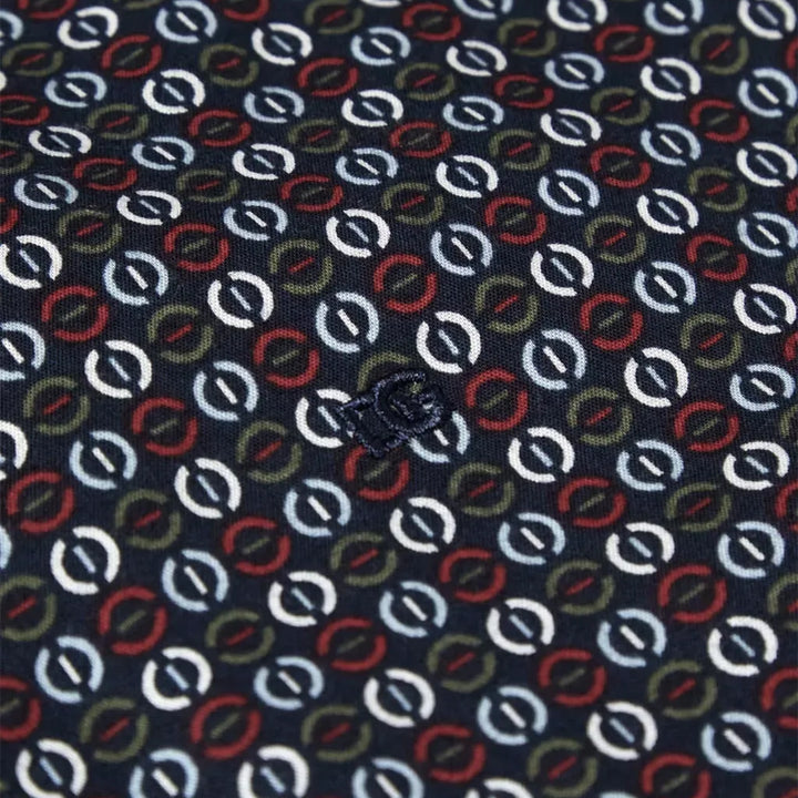 Patterned fabric with circular shapes in red, green, and white on a blue background