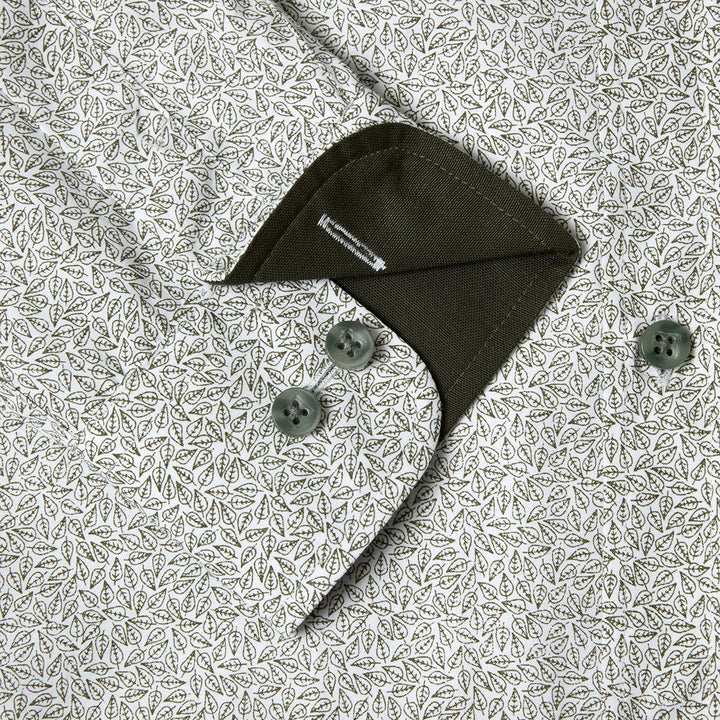 Green shirt with buttons on a patterned fabric background