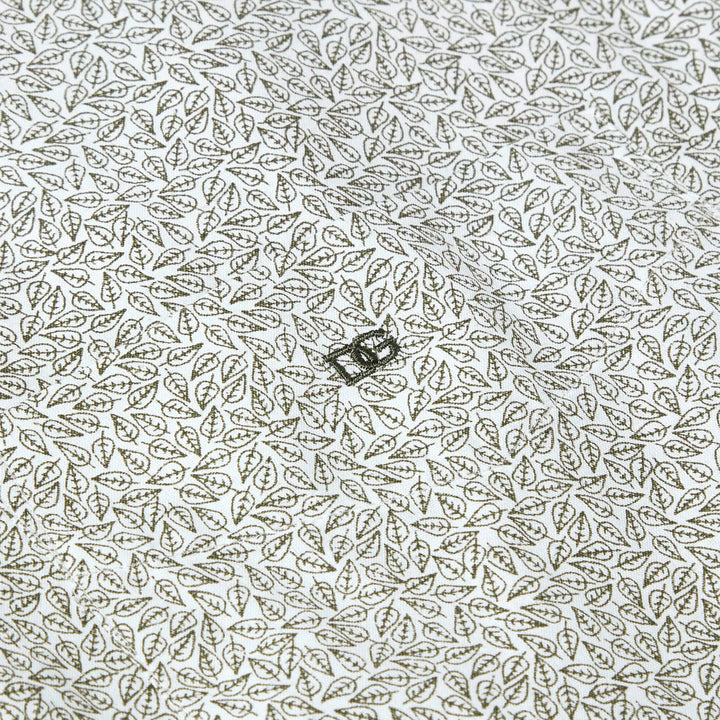Patterned fabric with a small greenrectangular object on a white background
