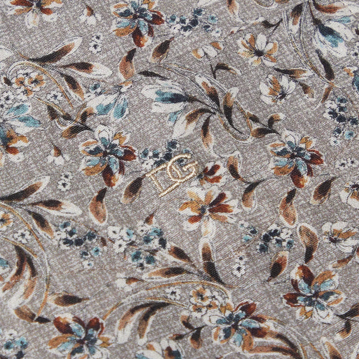 Floral patterned fabric with brown, blue, and white colors on a gray background