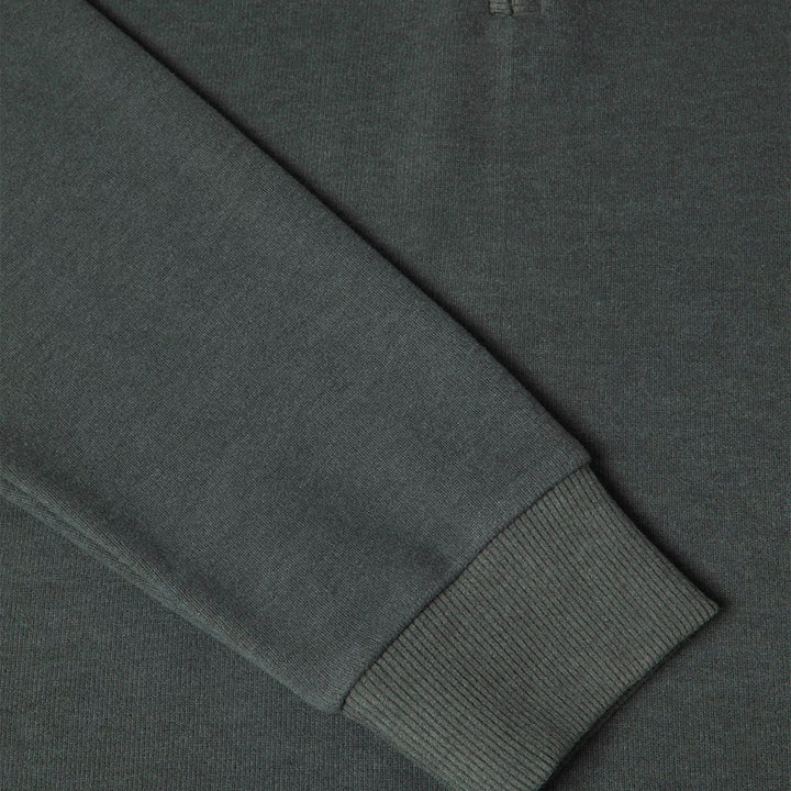 Close-up of a dark gray sweatshirt with a ribbed cuff.