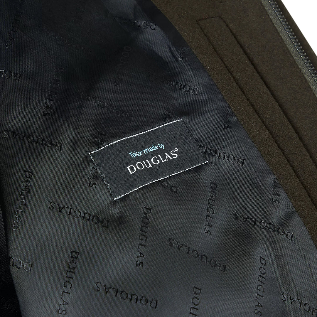 Close-up of a garment with 'Tailor made by Douglas' label on a dark fabric background.