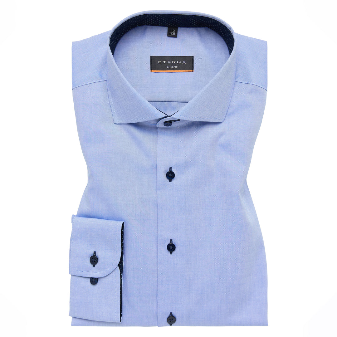 Light blue dress shirt with black buttons on a white background