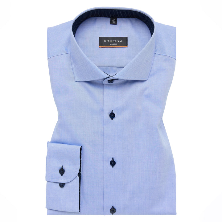 Light blue dress shirt with black buttons on a white background