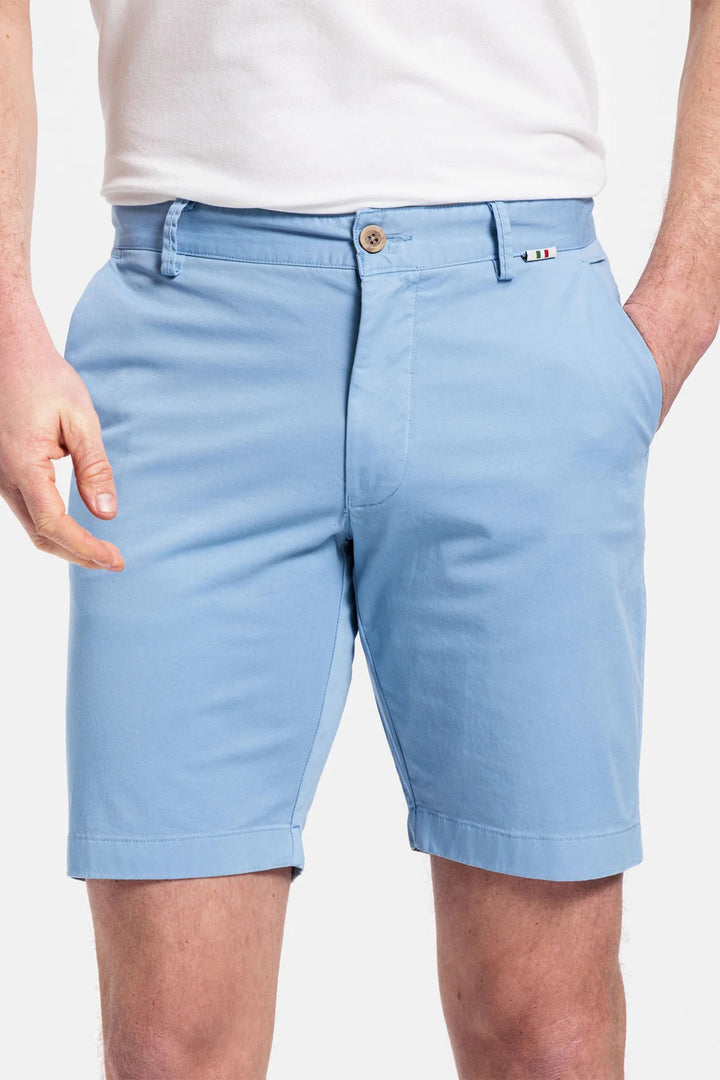 Light blue shorts worn by a person on a plain background