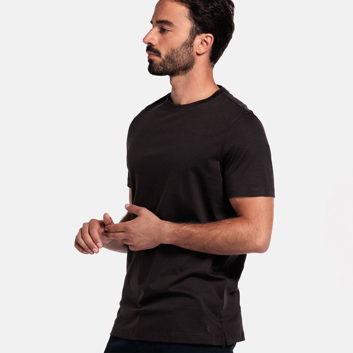 Man wearing a brown t-shirt against a plain background