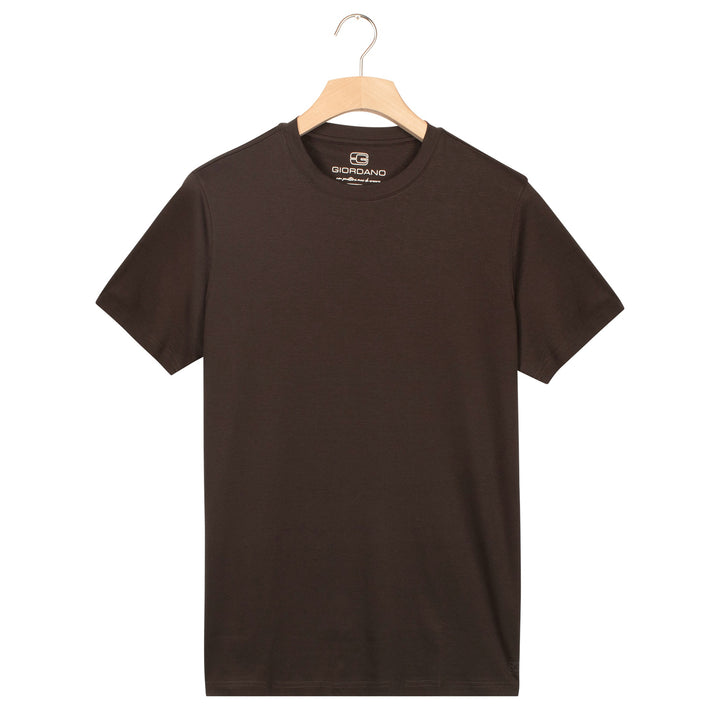 Brown t-shirt on a hanger with a visible brand label against a white background