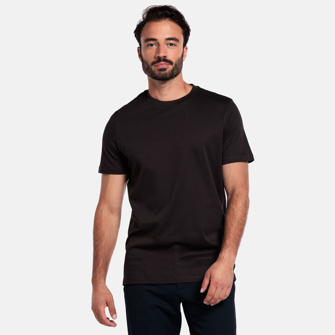 Man wearing a brown t-shirt against a plain background