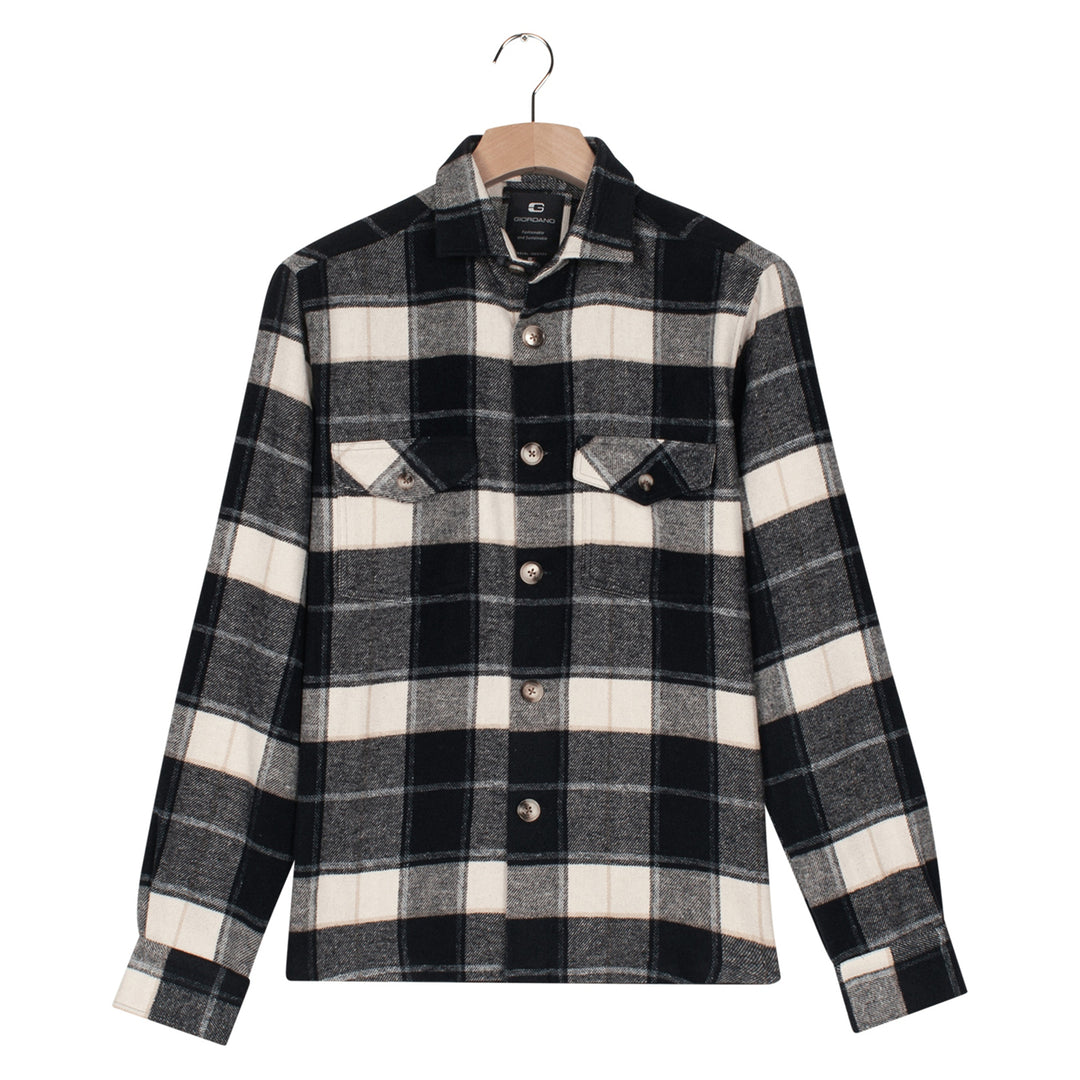 Black and white plaid shirt on a hanger against a white background