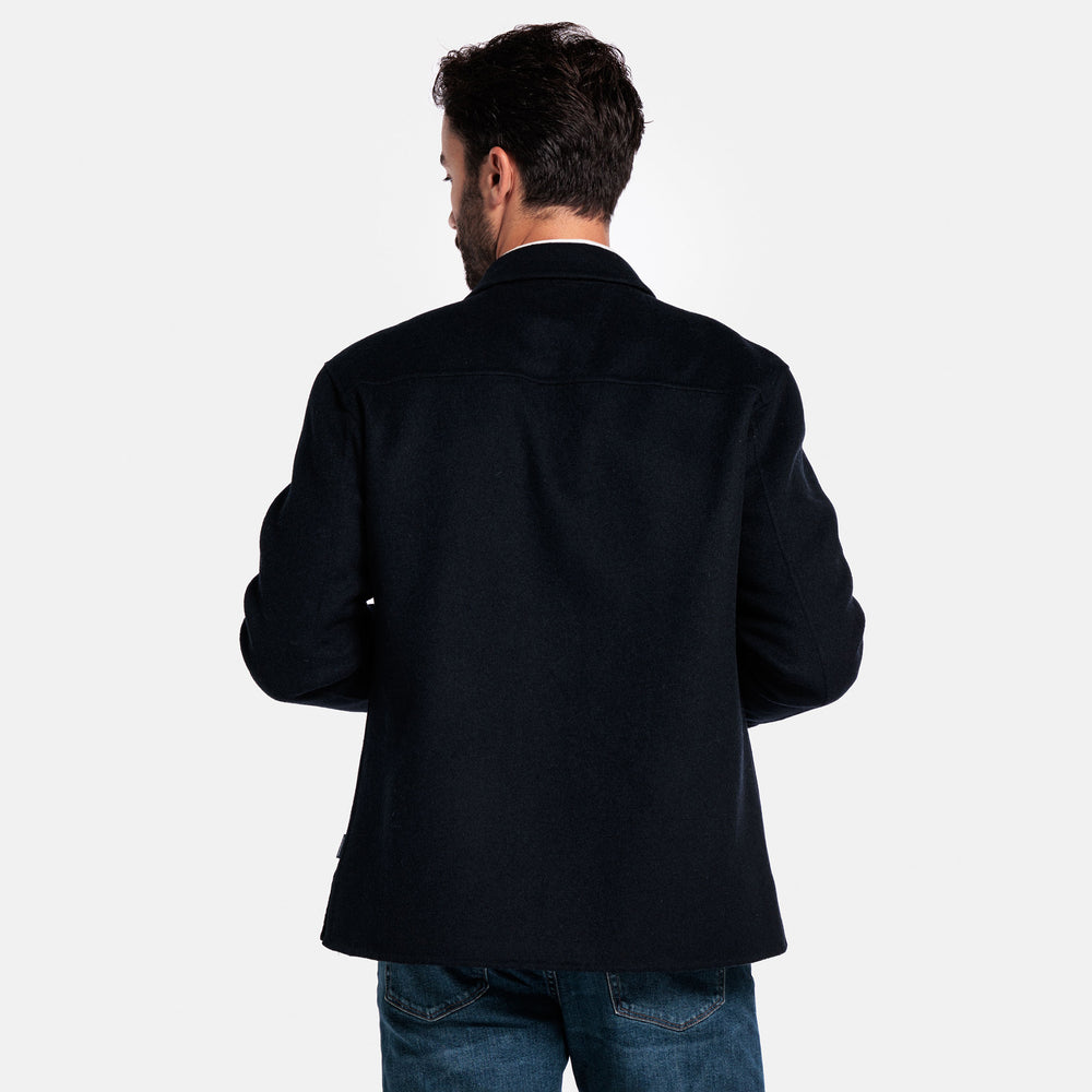 Man wearing a black coat from behind on a white background