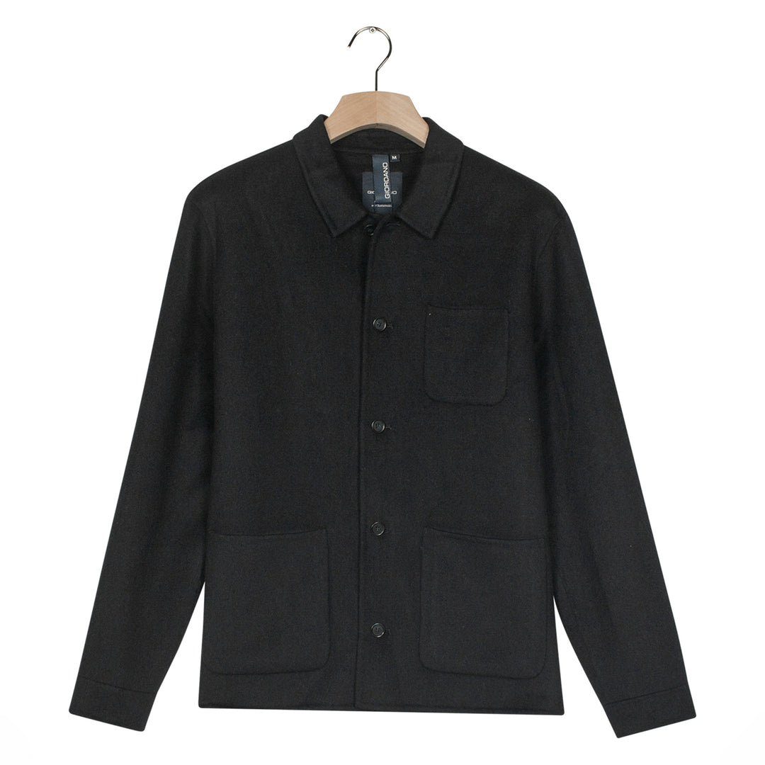 Black jacket on a hanger against a white background