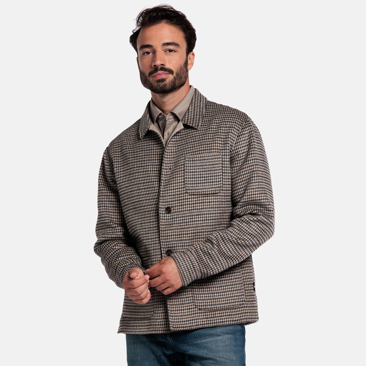 Man wearing a checkered jacket on a plain background
