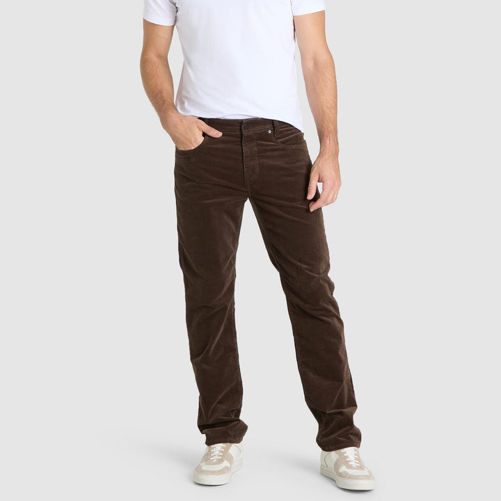 Person wearing brown corduroy pants on a white background