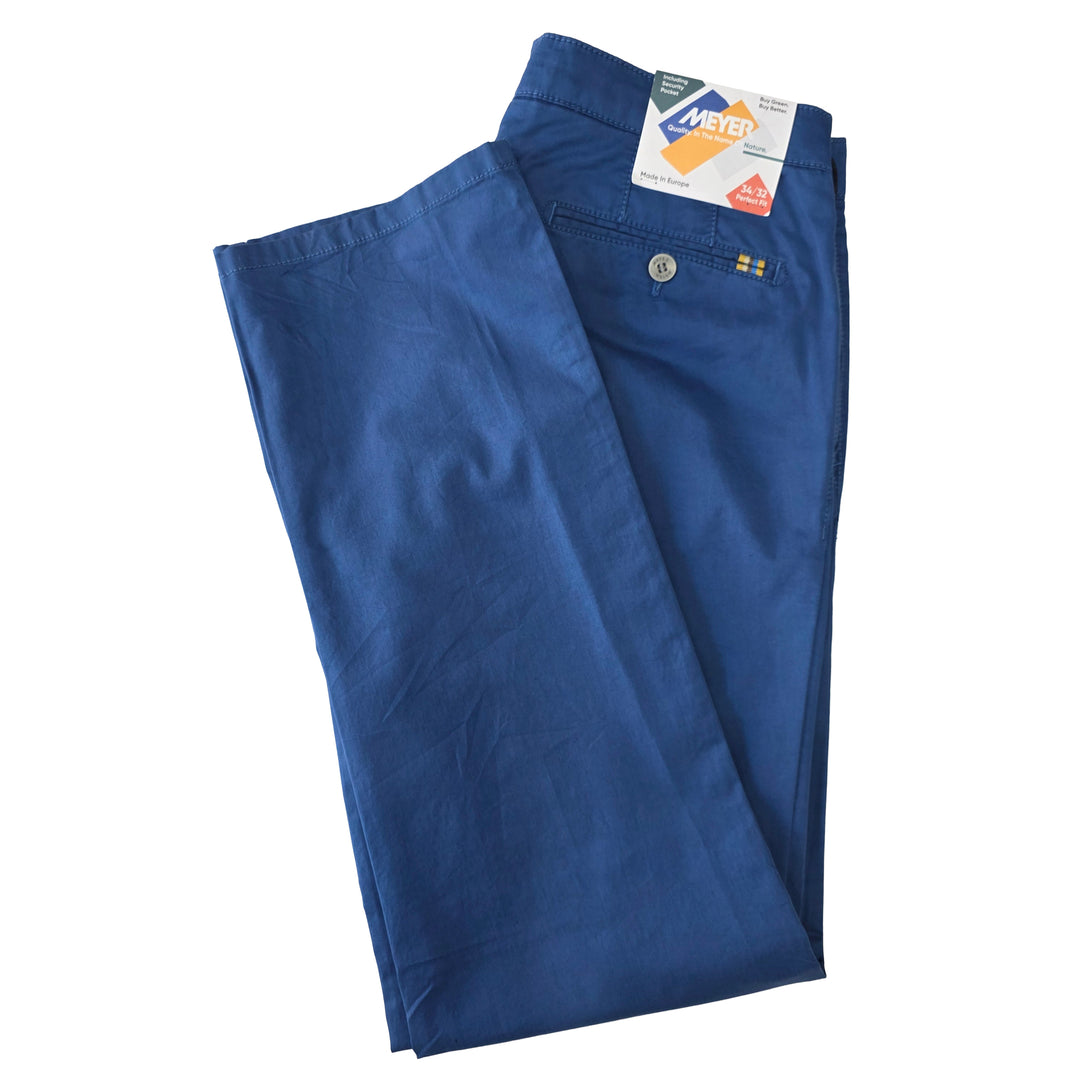 Folded blue pants with a brand tag on a white background