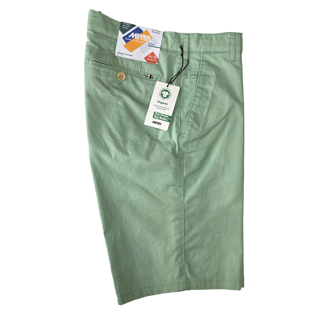 Green shorts with tags on a white background