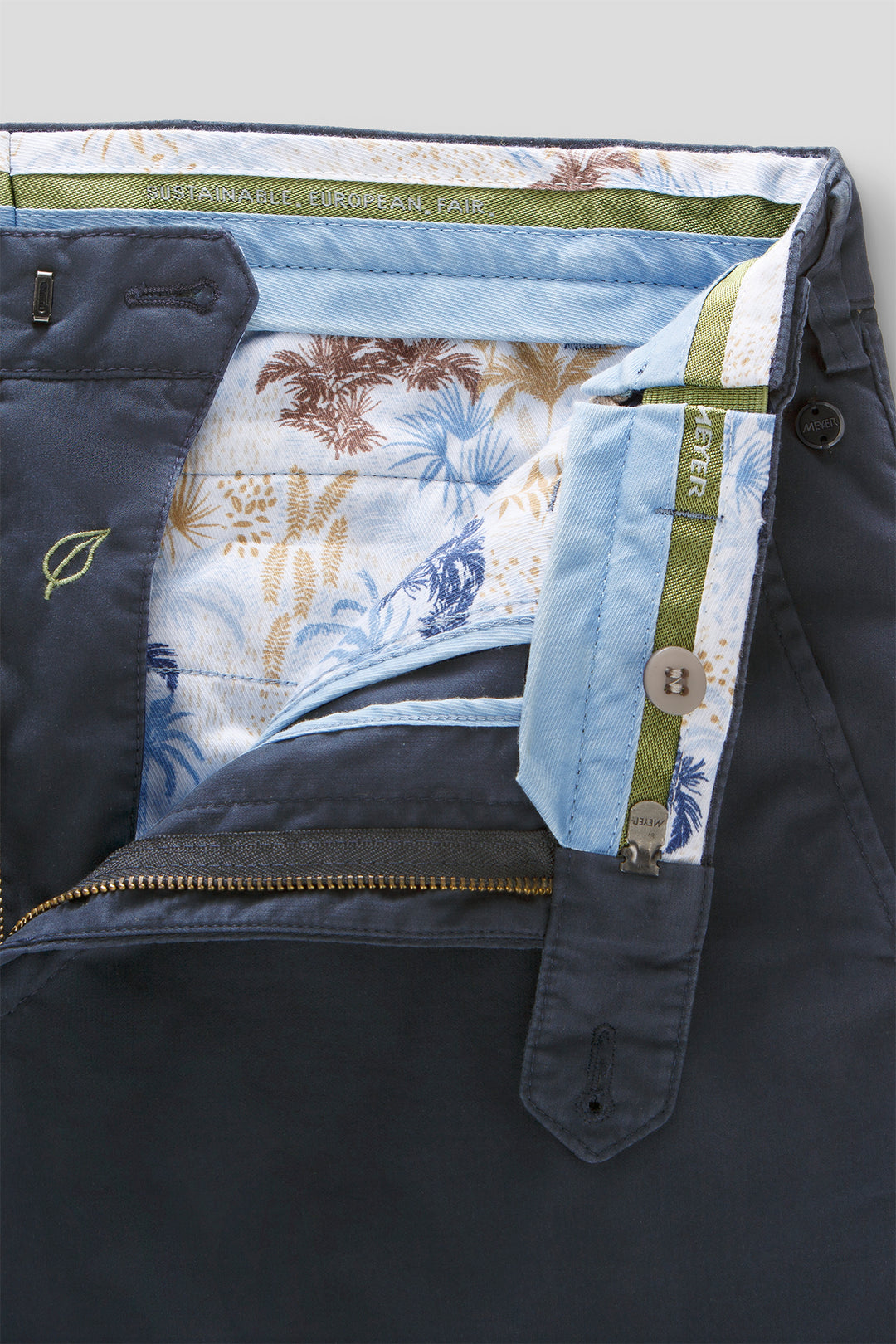 Close-up of a jacket with floral lining and visible brand logo.