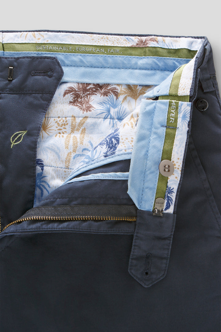 Close-up of a jacket with floral lining and visible brand logo.