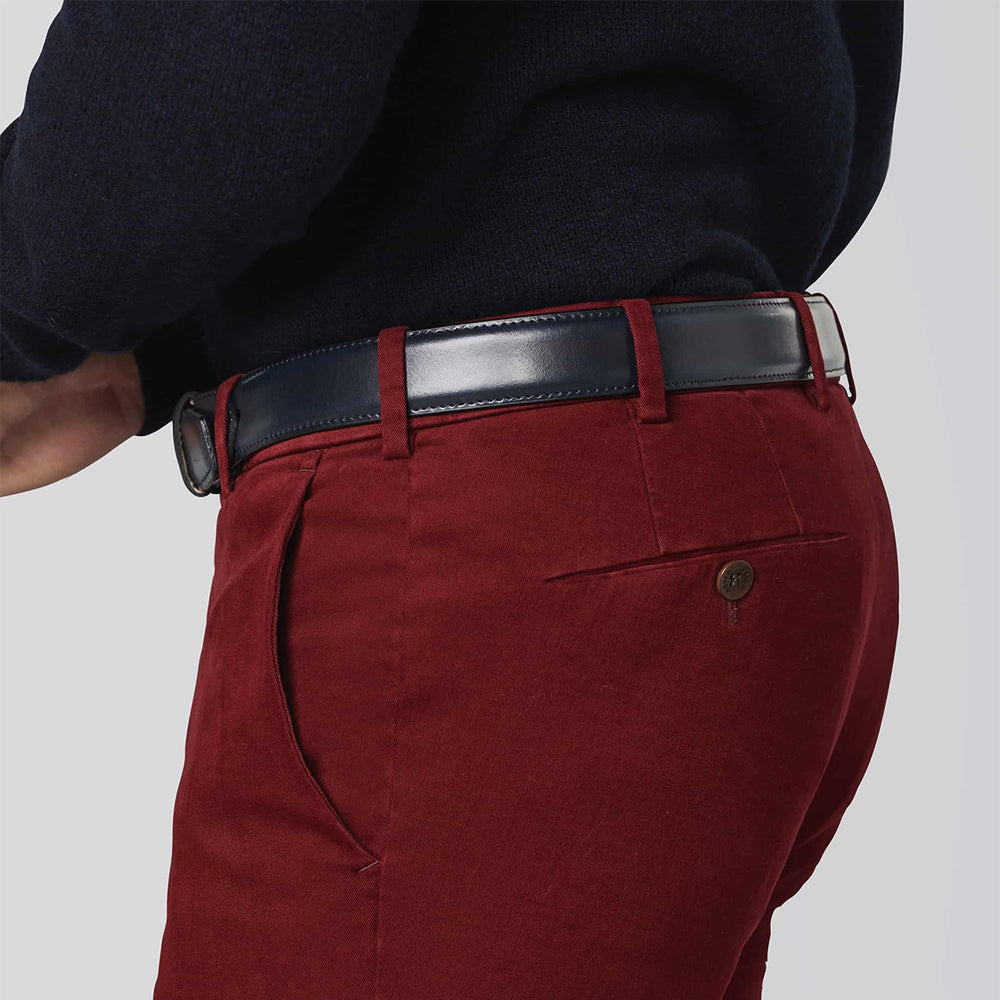 Red pants with a black belt on a gray background