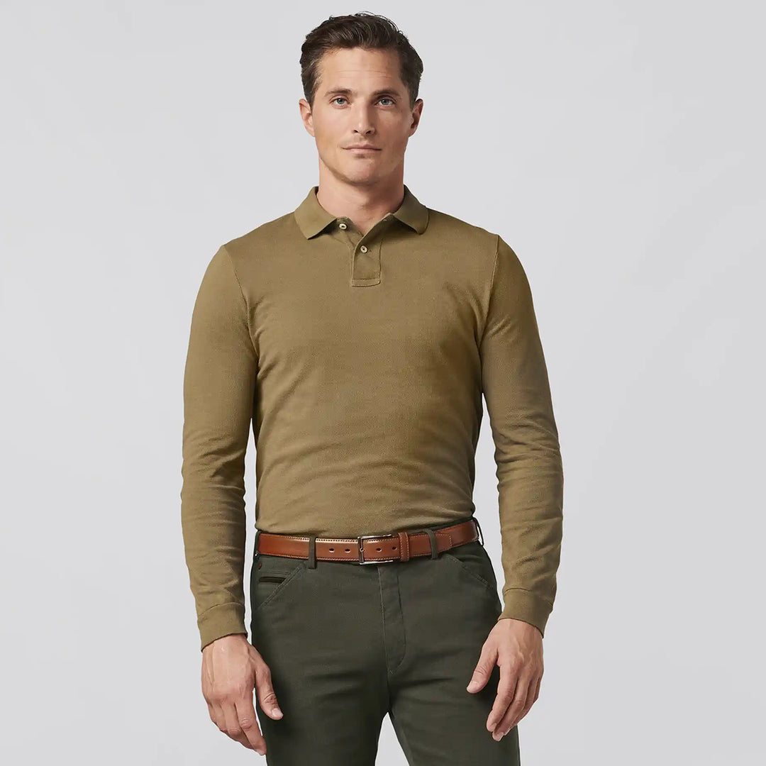 Man wearing a green long-sleeve polo shirt and green pants on a light gray background