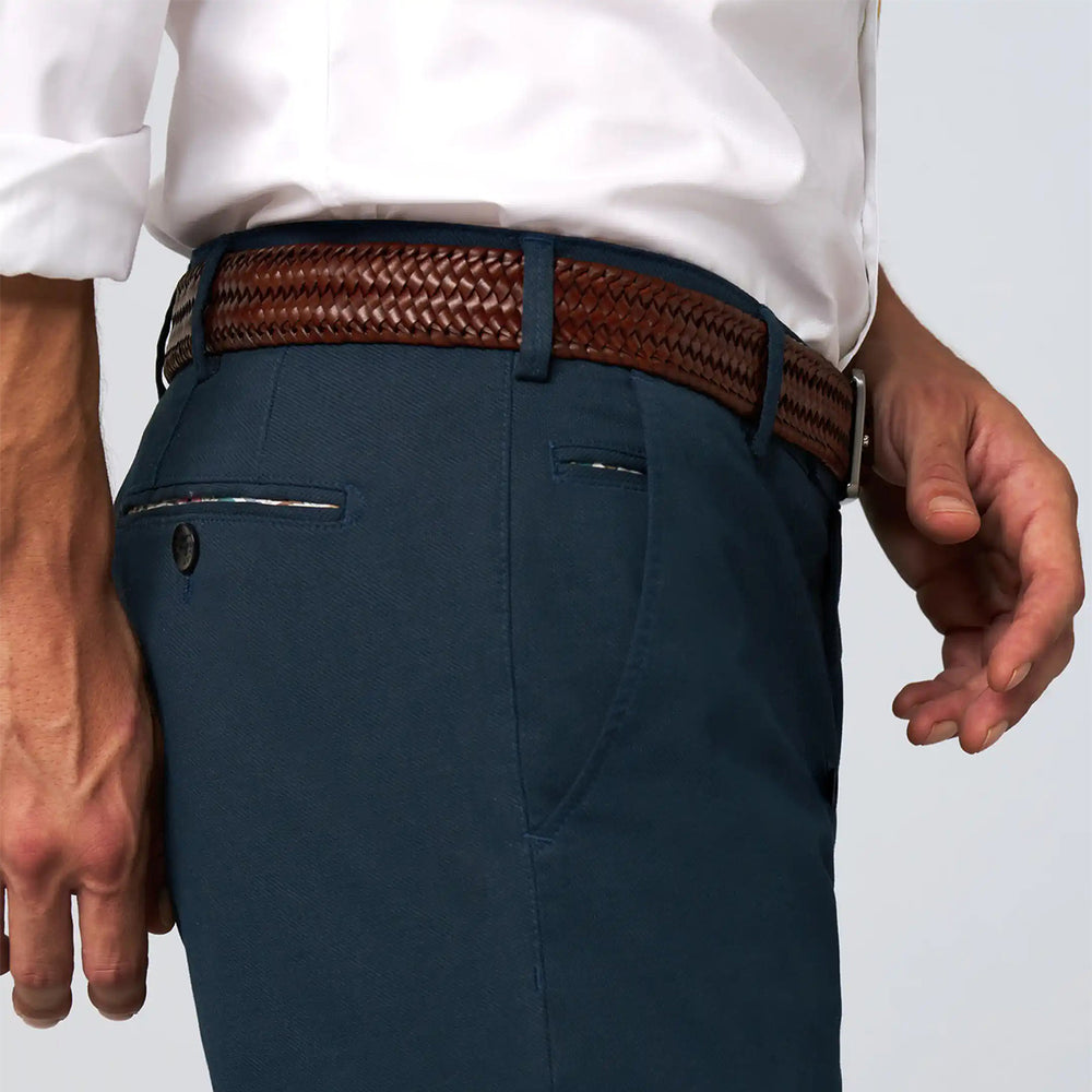 Navy pants with a brown belt on a plain background