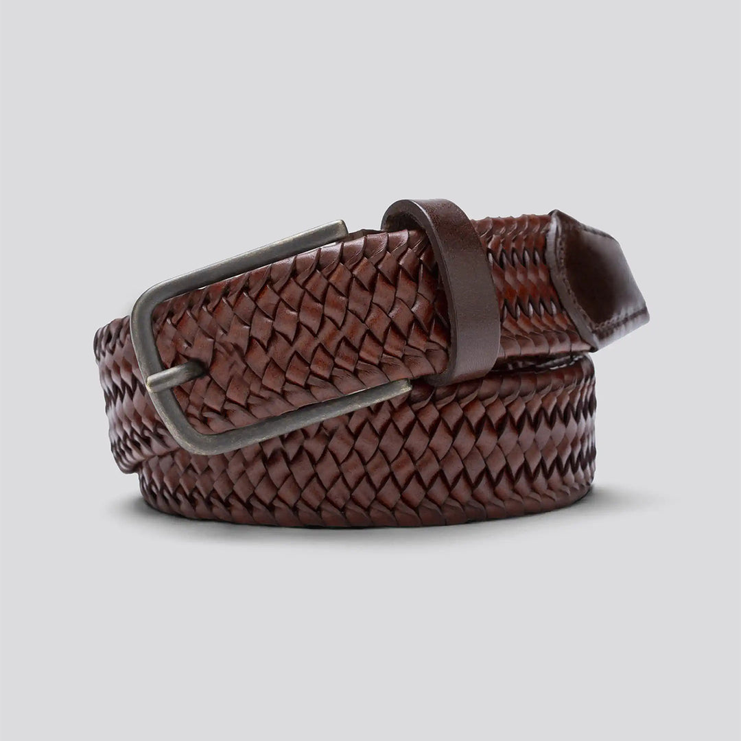 Brown woven belt with a silver buckle on a light gray background