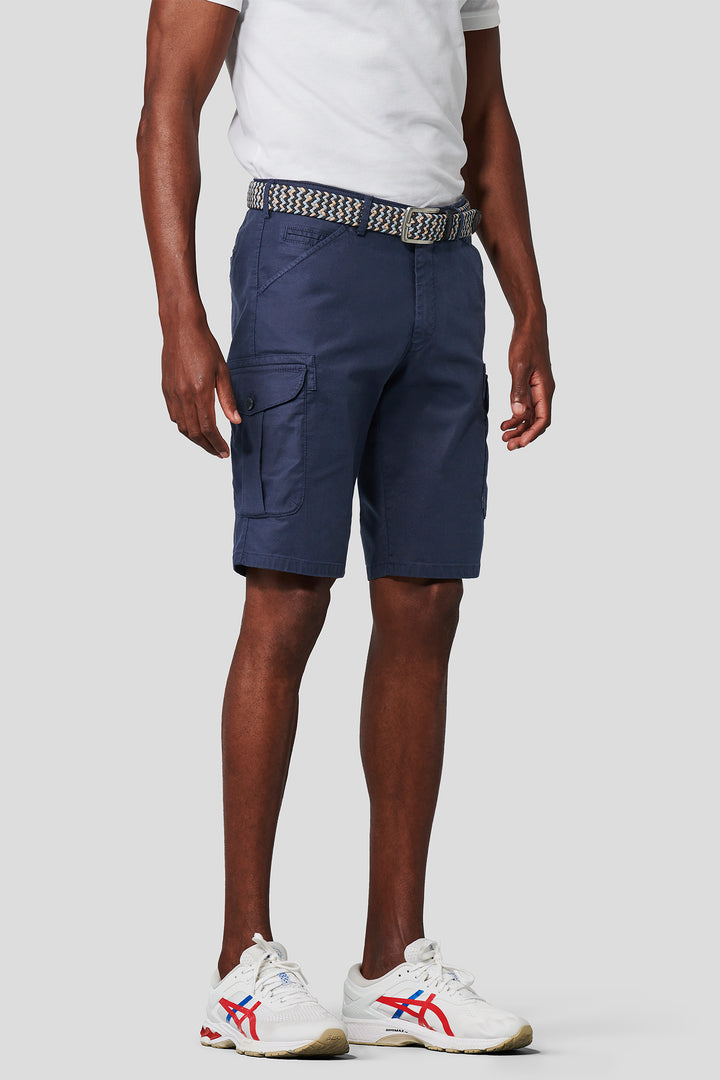 Person wearing navy cargo shorts on a white background
