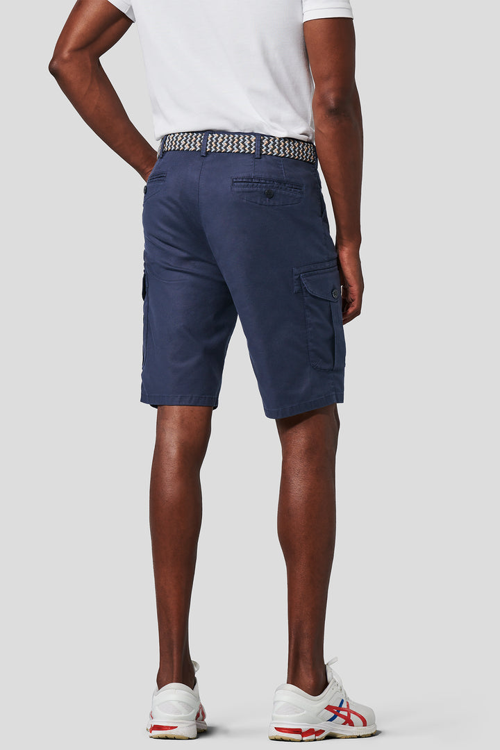Person wearing navy cargo shorts on a white background