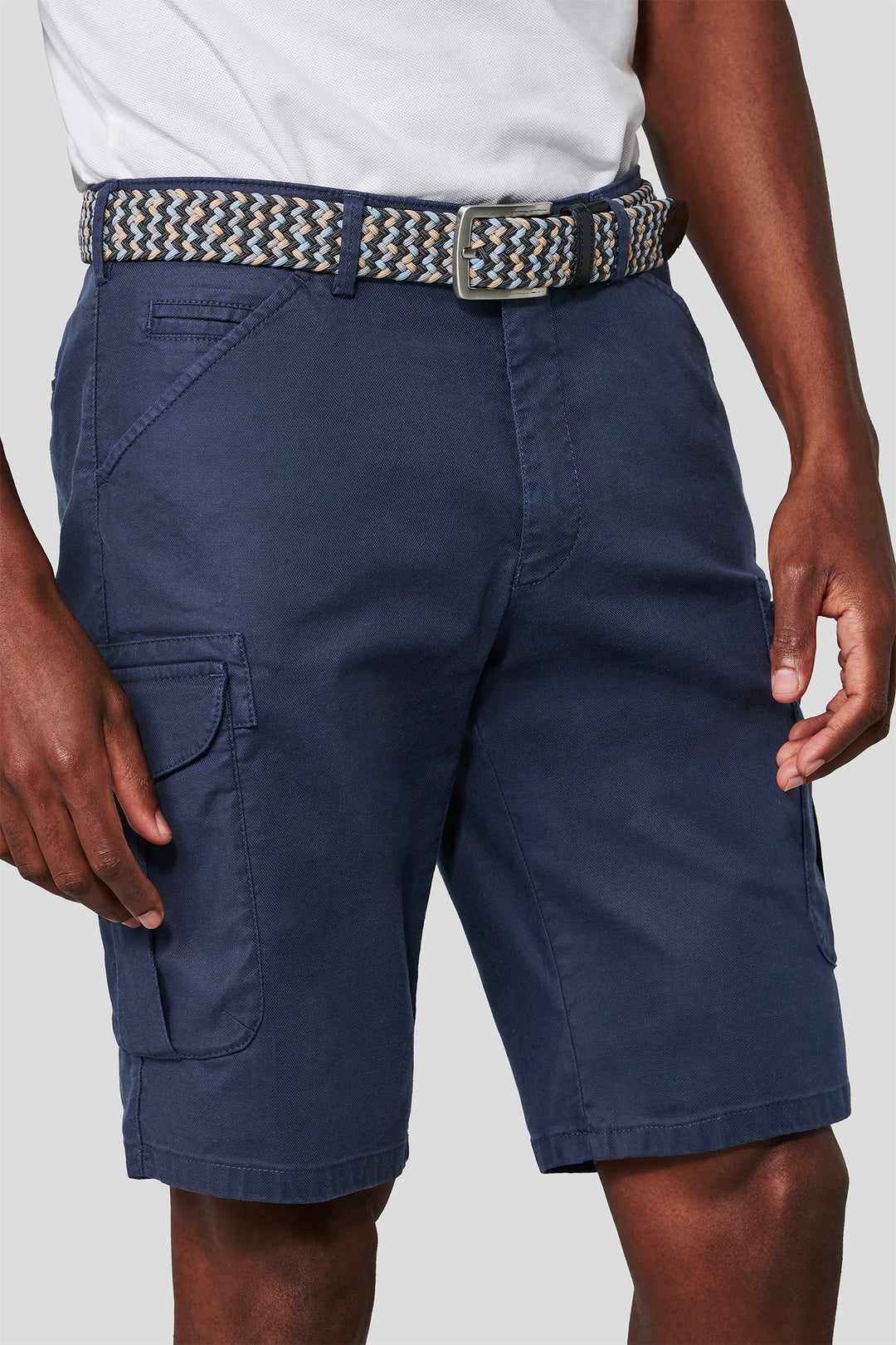 Navy cargo shorts with a belt on a plain background