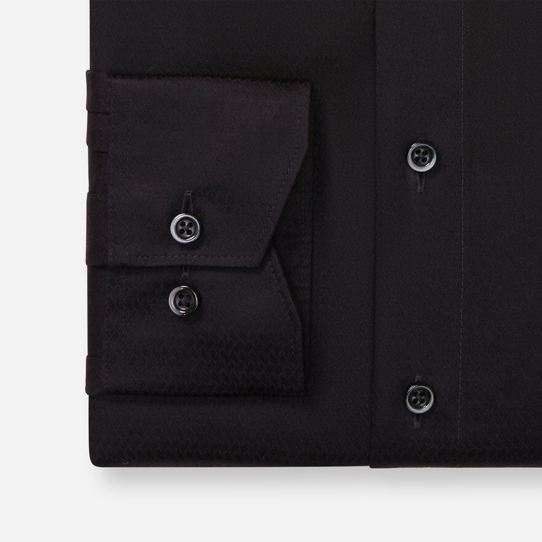 Black dress shirt with button details on a white background
