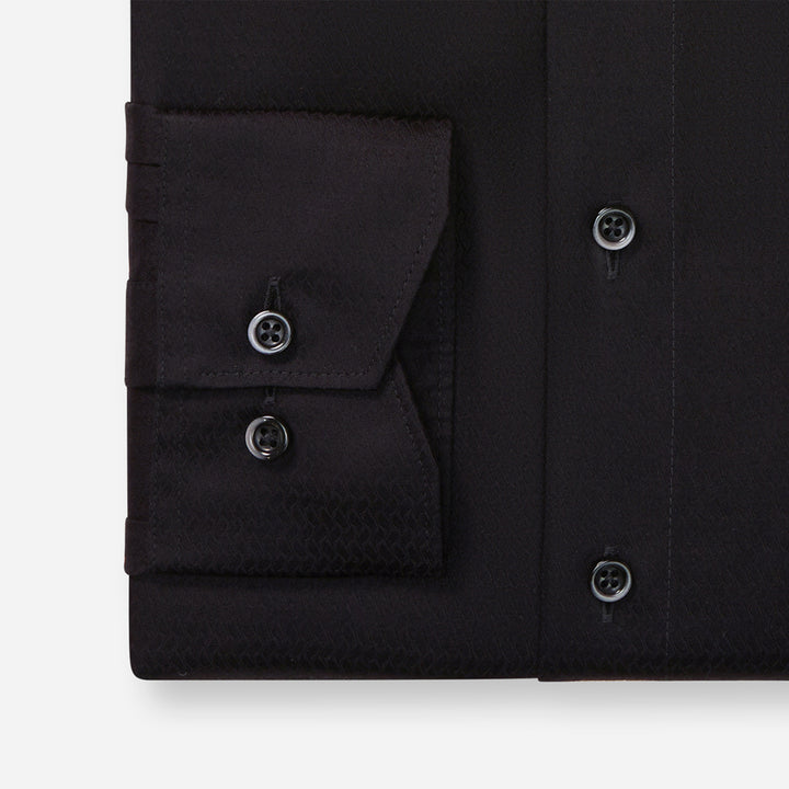 Black dress shirt with button details on a white background