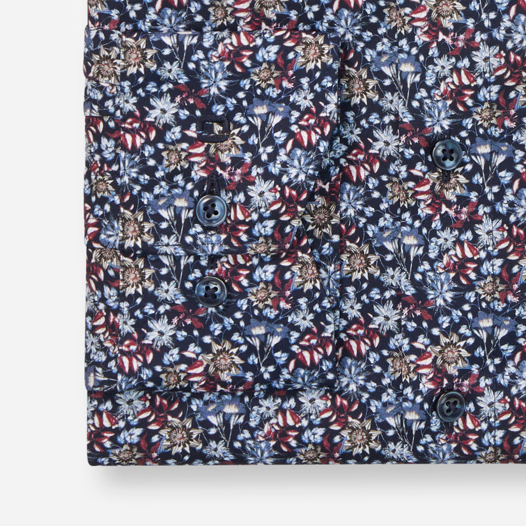 Floral patterned shirt with a mix of blue, red, and white colors on a white background