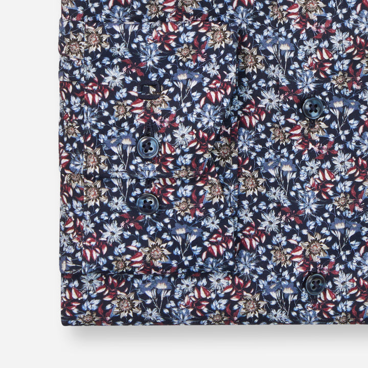 Floral patterned shirt with a mix of blue, red, and white colors on a white background