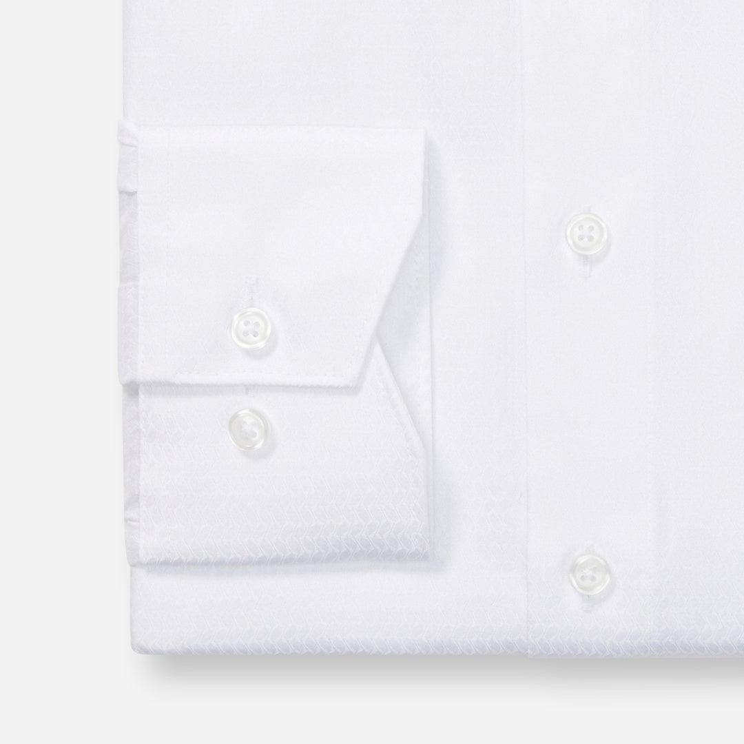 Folded white shirt on a light gray background