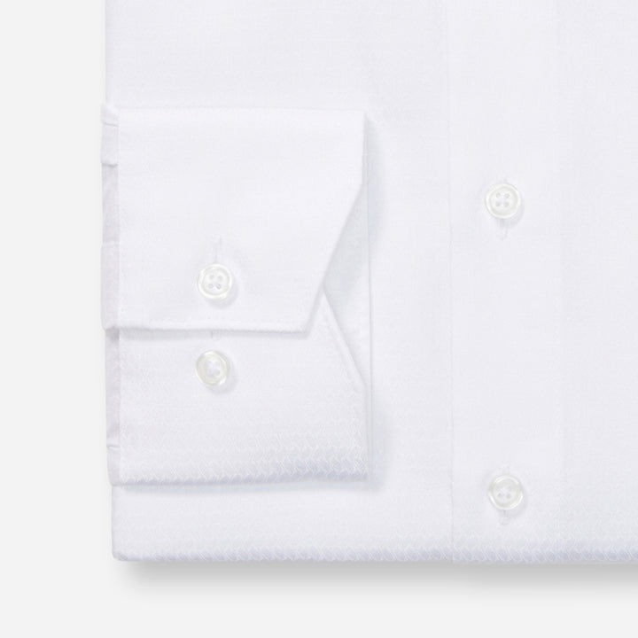 Folded white shirt on a light gray background